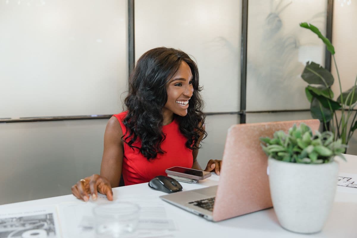 A business owner following up with clients from her laptop