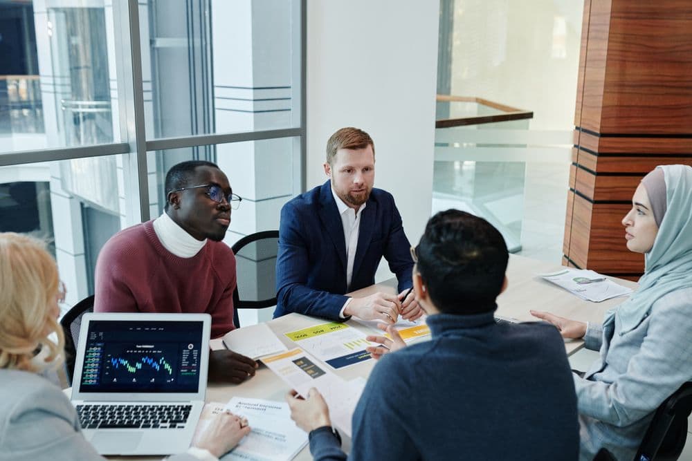 Colleagues reviewing financial reports together